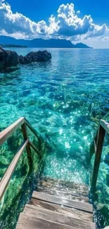 Stunning turquoise ocean view with wooden stairs and clear sky.