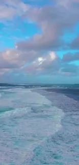 Serene ocean with waves and a blue sky.