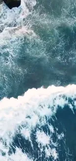 Aerial view of a serene ocean wave forming on the blue sea.