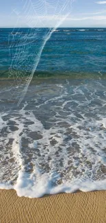 Ocean waves gently reach a sandy beach, with a serene blue sea under a clear sky.