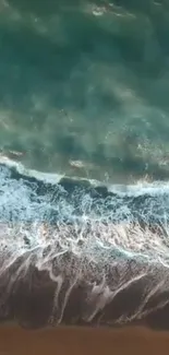 Aerial view of tranquil ocean waves crashing on a sandy beach.