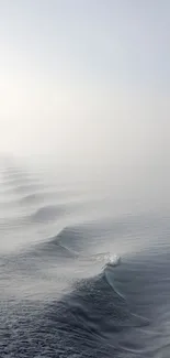 Serene ocean wave mobile wallpaper with misty horizon and calming textures.