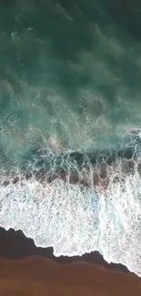 Aerial view of ocean waves gently crashing on the sandy beach for a calming background.