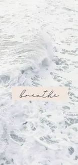 Calming ocean waves with word 'breathe' on a mobile wallpaper.