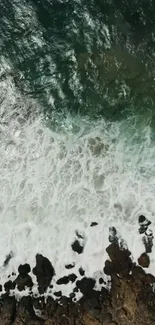 Aerial view of ocean waves crashing on a rocky shore for mobile wallpaper.