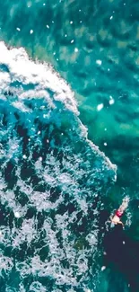 Aerial view of turquoise ocean waves crashing dynamically.