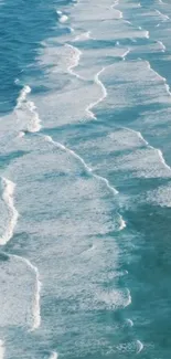 Serene blue ocean waves with white foam on a peaceful beach.