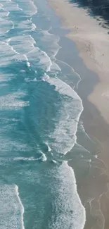 Aerial view of gentle ocean waves meeting a sandy beach.