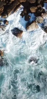 Aerial view of ocean waves crashing over rocks.