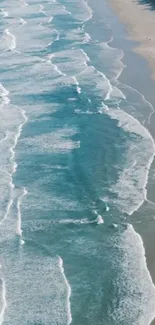 Aerial view of serene ocean waves and sandy beach.