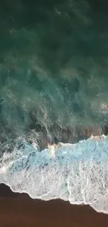 Aerial view of serene ocean waves crashing against the beach.