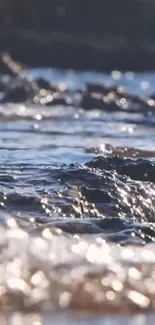 Serene ocean waves with sparkling water under sunlight.