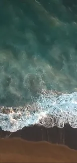 Aerial view of serene ocean waves crashing on a sandy beach with azure waters.