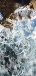 Aerial view of crashing ocean waves on rocky cliffs.