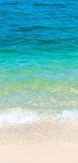 Serene ocean waves with sandy beach in vibrant blue hues.