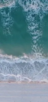 Serene turquoise ocean waves crashing on the sandy beach.