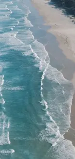 Aerial view of serene ocean waves meeting a sandy beach.