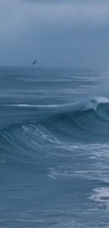 Calm ocean waves under a cloudy sky in soothing blue tones.