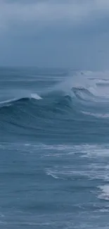 Serene blue ocean waves under a cloudy sky.