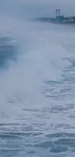 Serene ocean waves crash onto a beach with a distant coastal view.