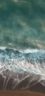 Aerial view of calm ocean waves on a sandy beach backdrop.