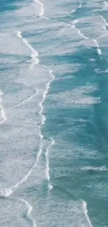 Aerial view of serene ocean waves with calming blue and white hues.