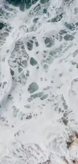 Aerial view of serene ocean waves with intricate patterns.