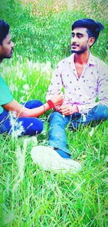 Two friends seated on a grassy field, sharing a peaceful moment.