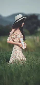 Woman in nature with hat and summer dress, surrounded by lush greenery.