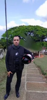 Person outdoors with helmet, lush green background.