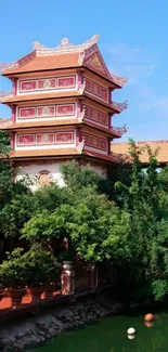 Serene pagoda near tranquil pond with lush greenery.