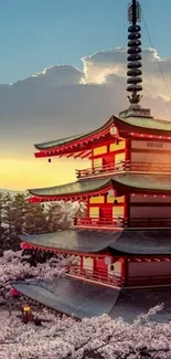 Japanese pagoda with cherry blossoms at sunset.