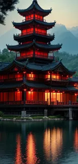 Beautiful pagoda reflected in calm lake with misty mountain background.