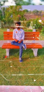 Young man on orange bench in a green park setting with floral patterns.