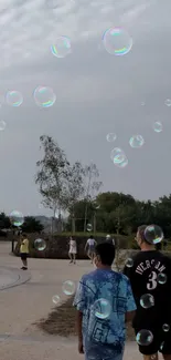 Serene park scene with floating bubbles and people walking.