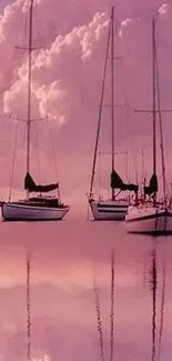 Sailboats reflecting in pink serene waters under fluffy clouds.