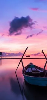 Serene boat at pink sunset on calm waters.