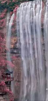 Serene waterfall with pink foliage and a pagoda, ideal for a calming phone wallpaper.