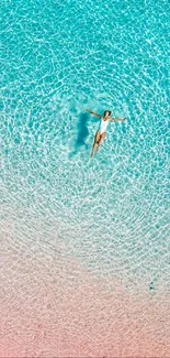 Aerial view of a person floating in a serene, clear blue pool.