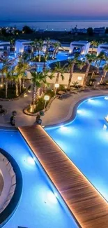 Serene nighttime view of a poolside resort with vibrant blue lighting.