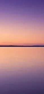 Purple sunset over calm waters, perfect for mobile wallpaper.