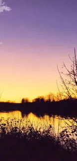 Serene purple sunset over a calm lake with tree silhouettes.