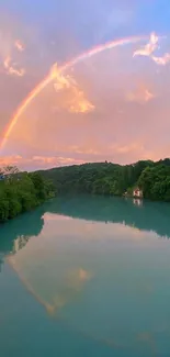 A vibrant rainbow over a serene lake at sunset, reflecting the sky's colors.