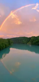 A colorful rainbow arches over a calm river surrounded by lush greenery.