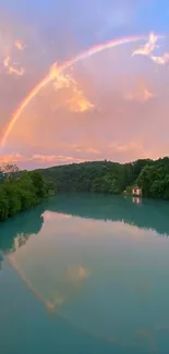 Rainbow over a serene river with lush green surroundings.