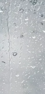 A serene wallpaper with raindrops on a transparent glass surface.