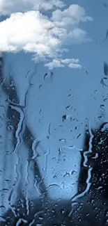 Raindrops on window with blue sky and clouds in serene wallpaper.