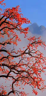 Red blossoms against blue sky with mountains