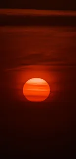 Serene red sunset wallpaper with a glowing sun.