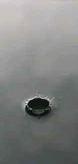 Serene water ripple effect in grey tones on a mobile wallpaper.